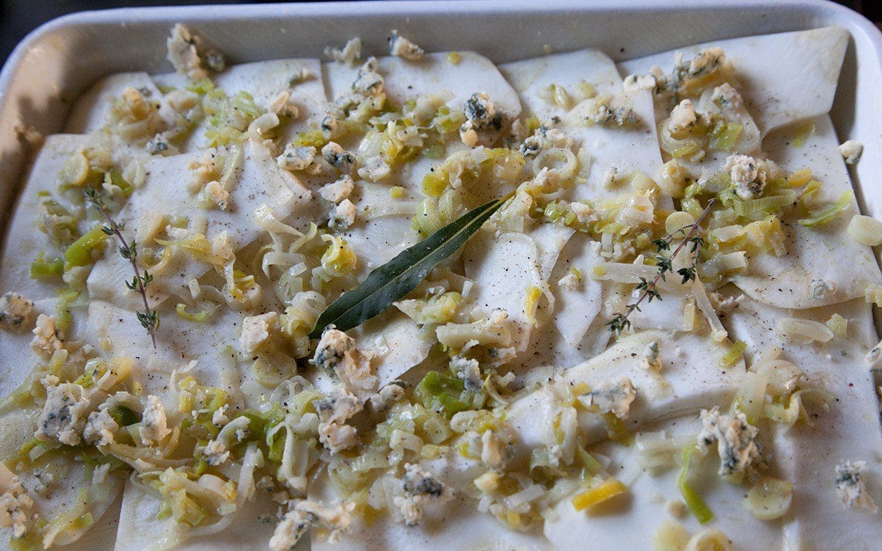 Assembling Celeriac and Leek Gratin. Photograph by Huw Morgan